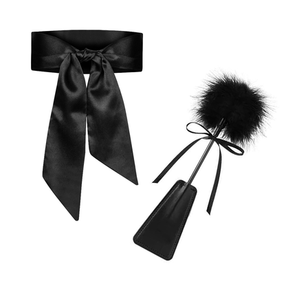 Bed restraints with positioning strap, blindfold, and feather riding crop