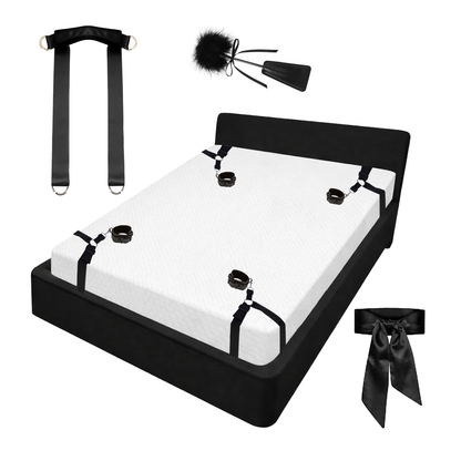 Bed restraints with positioning strap, blindfold, and feather riding crop
